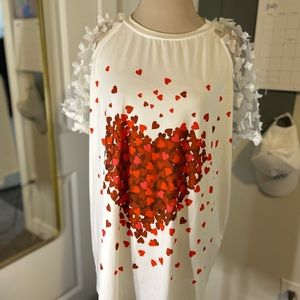 White shirt with red hearts
